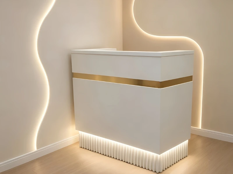 Grey reception desk with a raised counter and open knee space, seen from the front